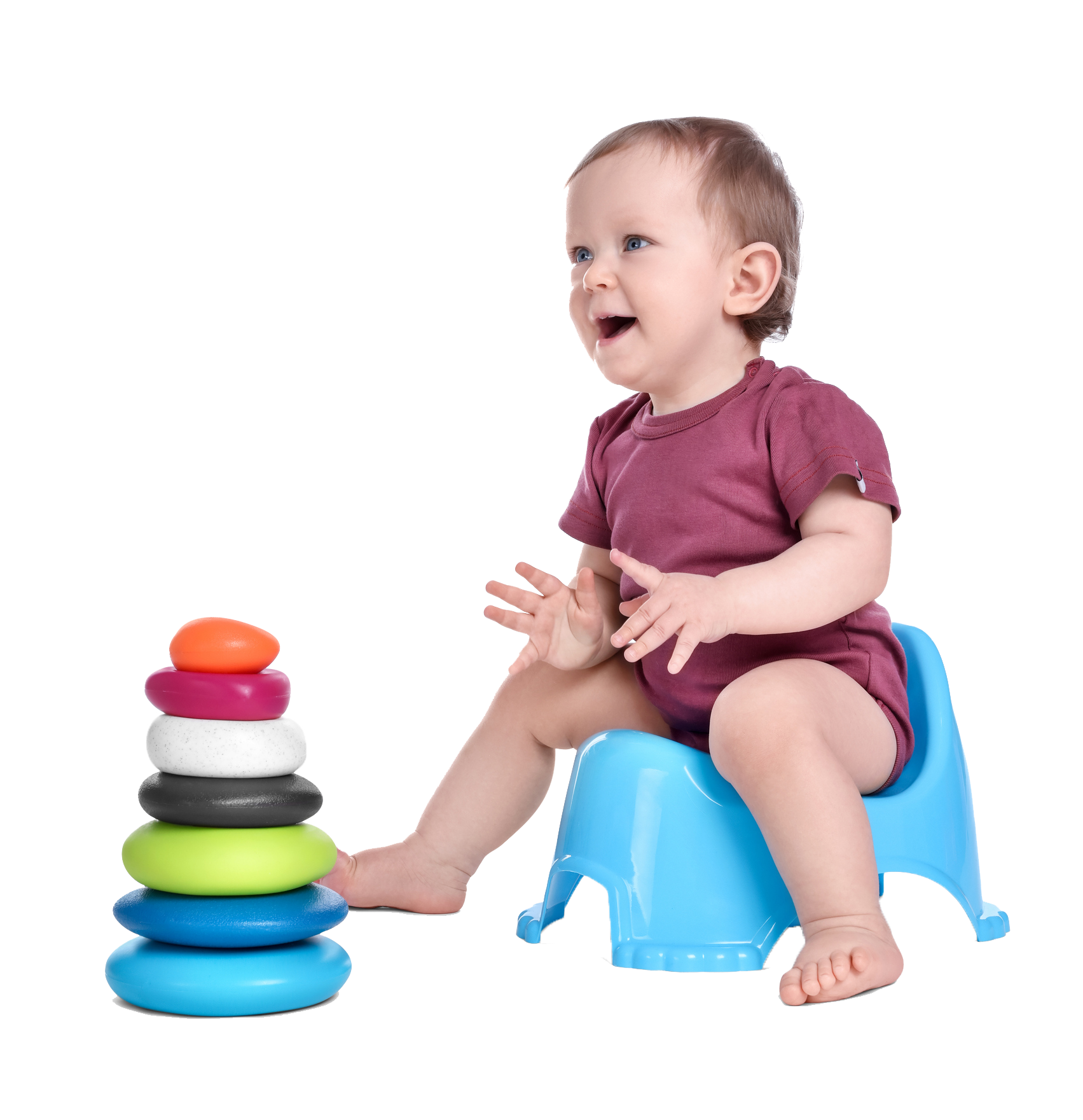 Baby sitting on a blue potty, smiling at a colorful stacking toy. Baby sitting on a blue potty, smiling at a colorful stacking toy.