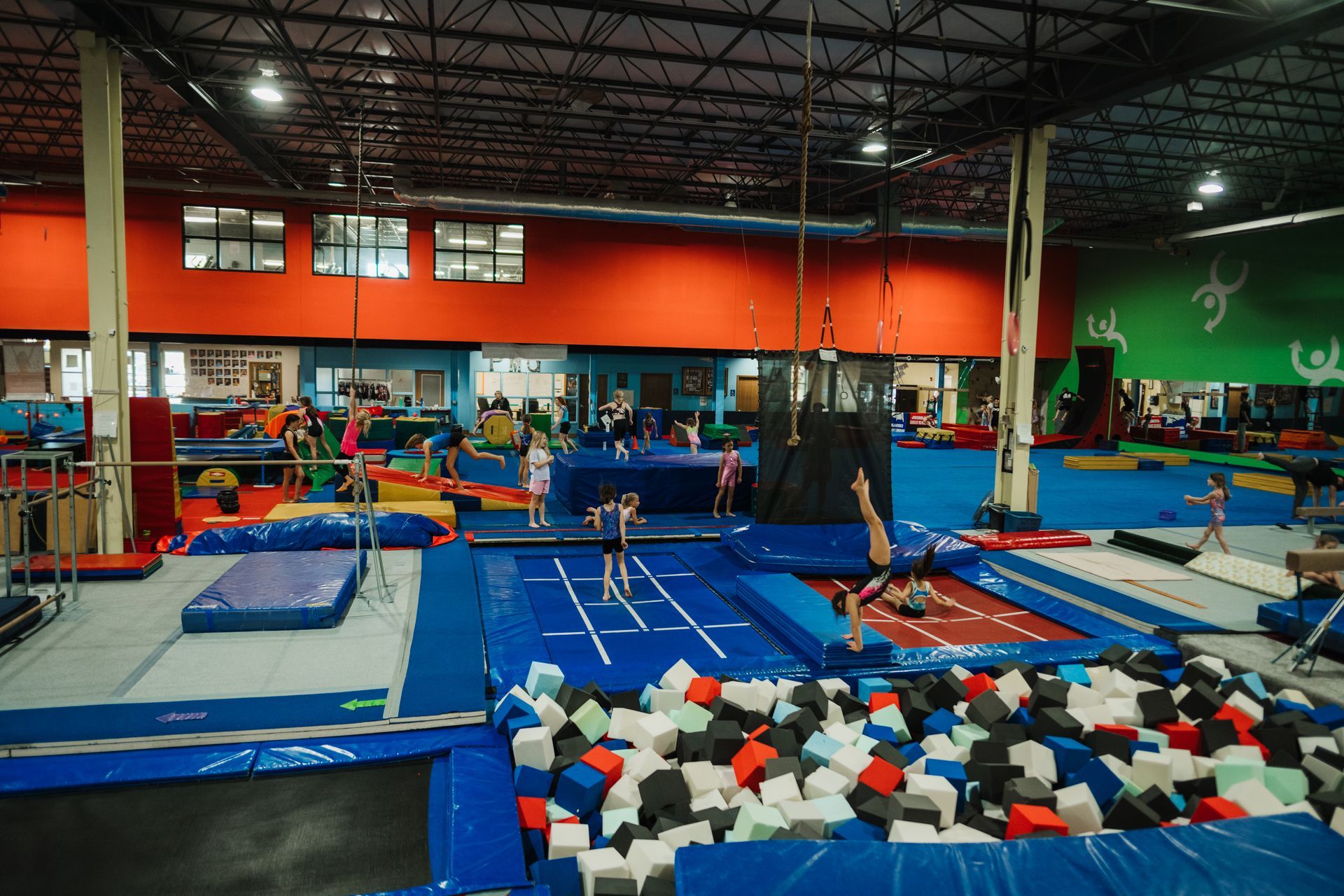 A group of people are doing gymnastics in a gym.