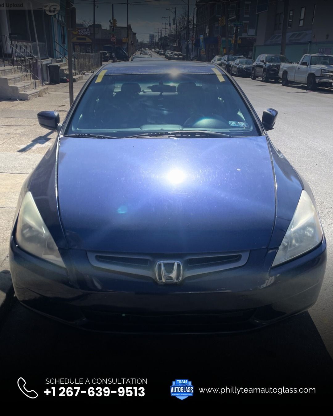 Blue Honda Accord parked on a city street.