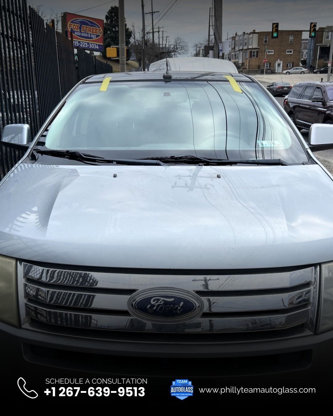 Silver Ford Edge SUV with a cracked windshield.