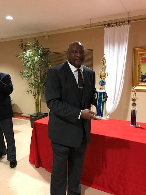 Man On Coat Holding The Trophy — St. Louis, MO — Par or Better Golf Club