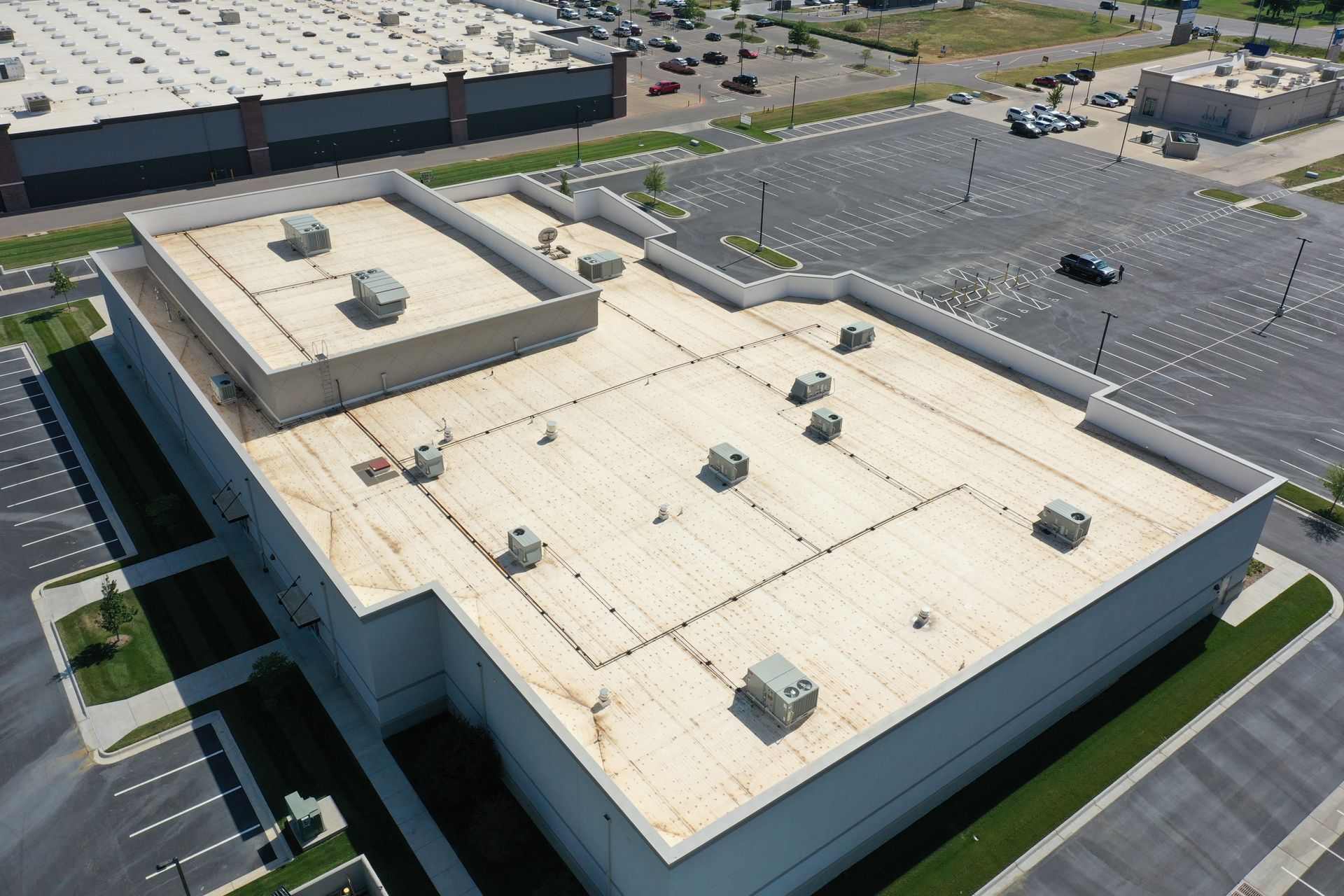 Aerial view of a new commercial membrane roof installation on a large facility in Wichita