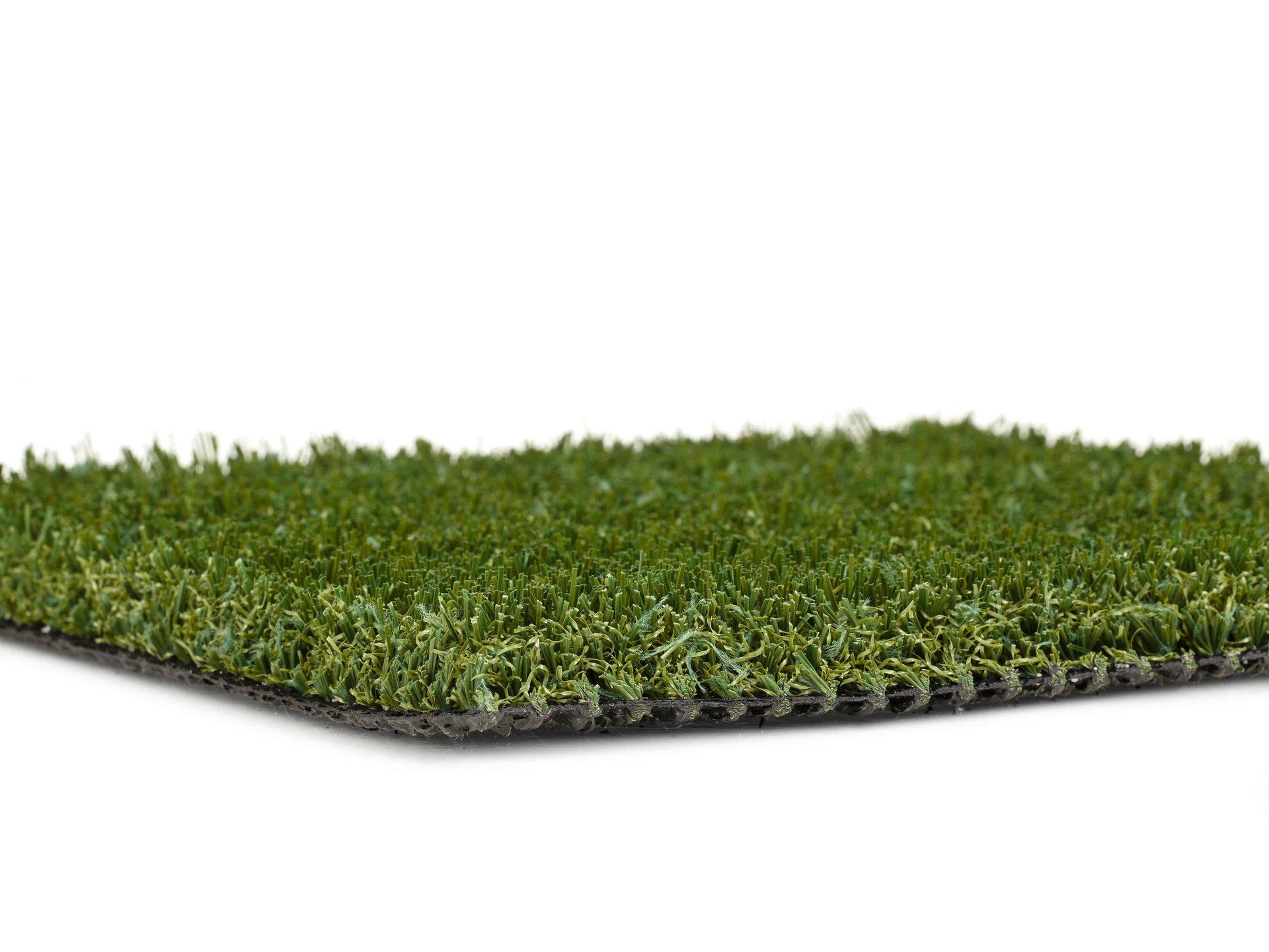 A close up of a piece of artificial grass on a white background.