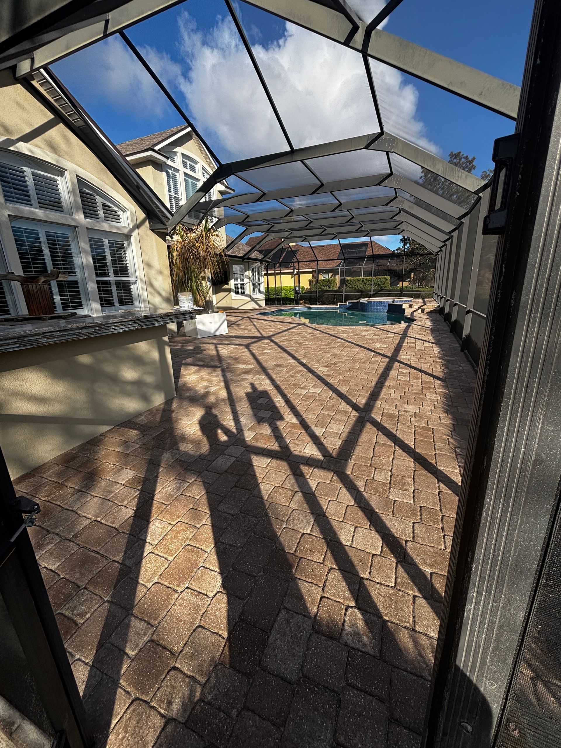 A large swimming pool with a slide in the backyard of a house.