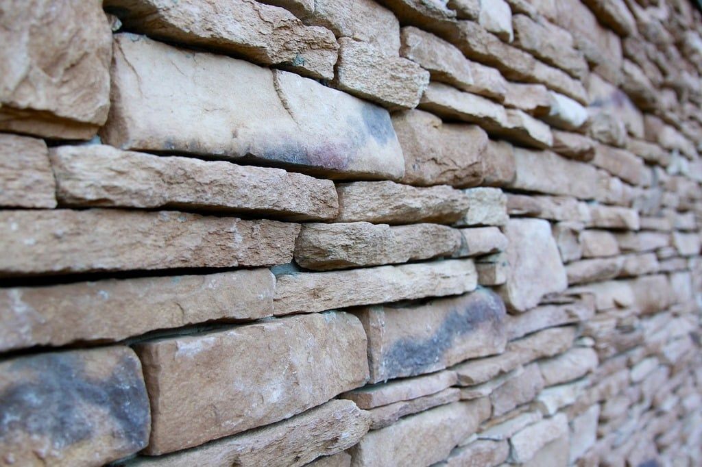 Stacked natural stone wall installed by Outdoor Transformations in Vilano Beach, FL.