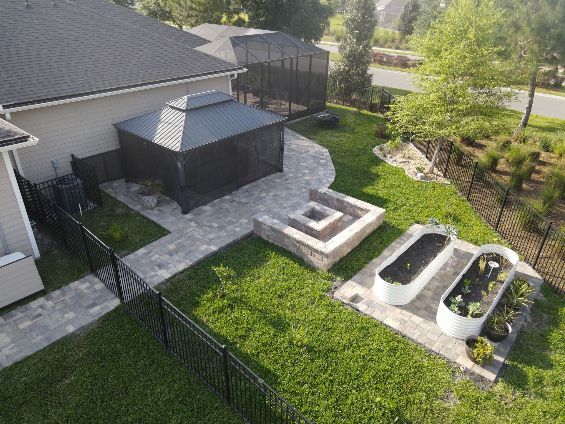 Outdoor Transformations installed a tremron paver fire pit in Ponte Vedra Beach, FL, for a seamless garden path.