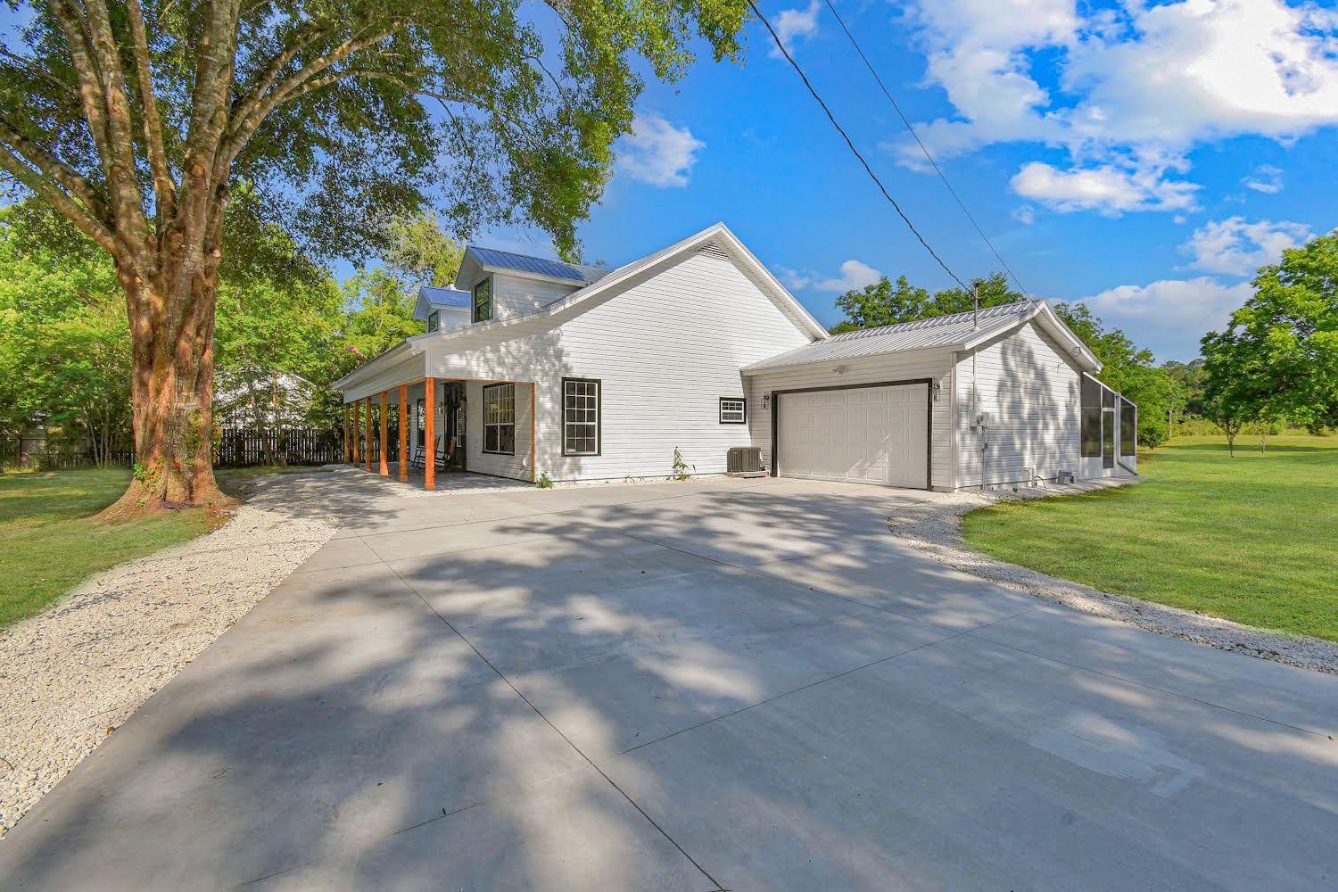 A large house with a concrete driveway 