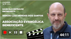 A video still of an interview with Sergio Luiz Mendes dos Santos, representing Associação Evangélica Beneficente. He's a middle-aged man, with a serious expression.