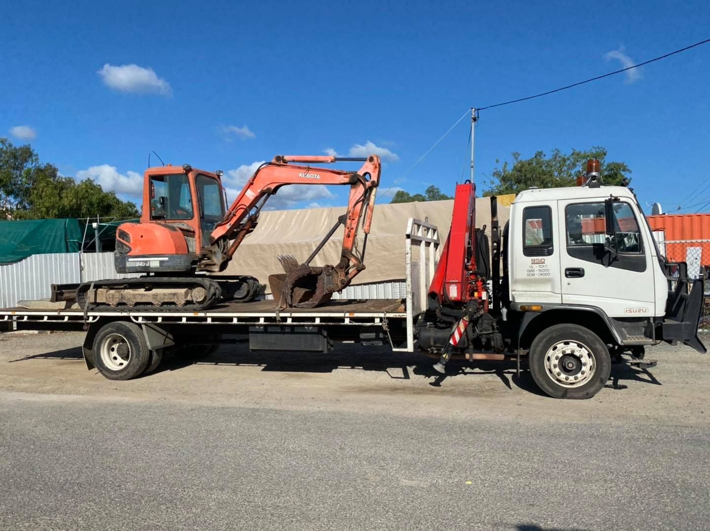 Orange Excavator on a Flatbed Truck With a Red Crane — Bob’s Trailer Trash in Yeppoon, QLD