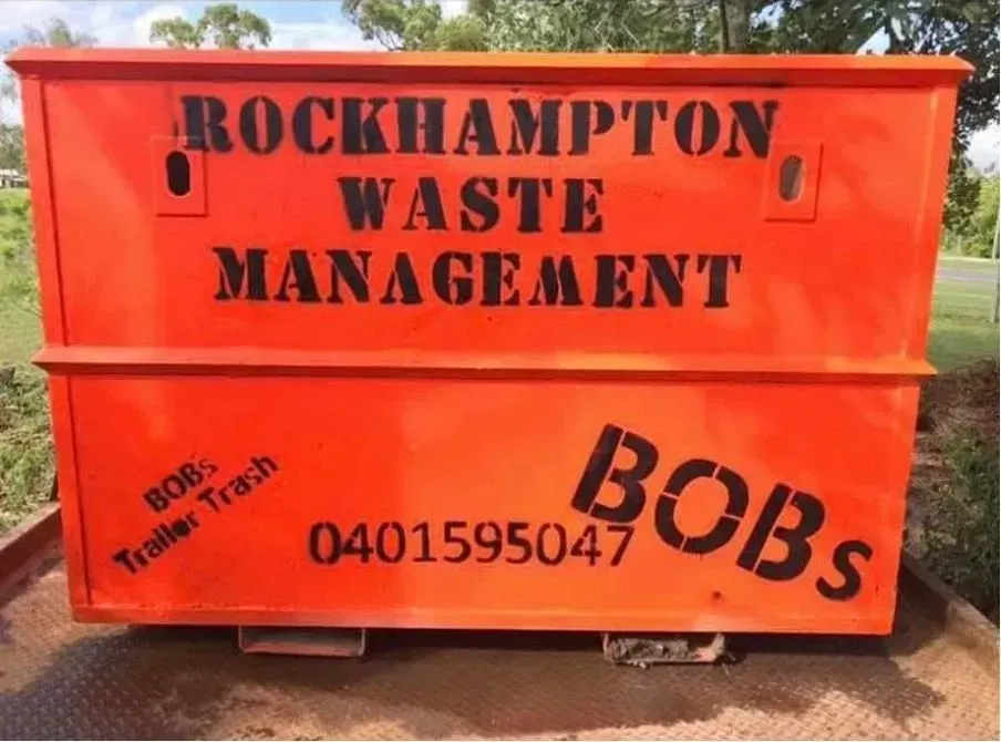 Orange Dumpster With Black Text: Rockhampton Waste Management — Bob’s Trailer Trash in Rockhampton, QLD