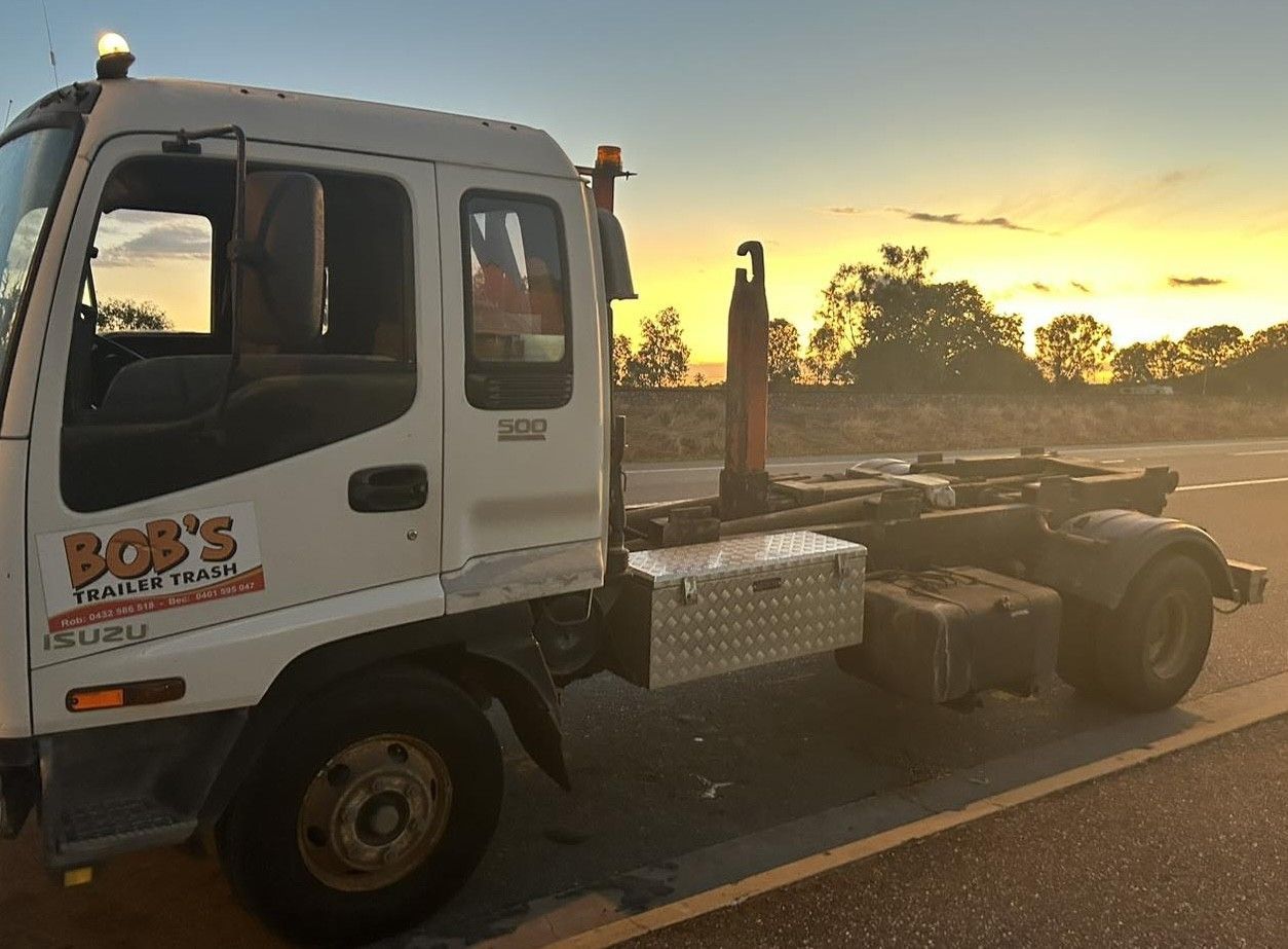White Isuzu Truck With Bob's Truck Services Logo, Parked on a Road at Sunset — Bob’s Trailer Trash in Rockhampton, QLD