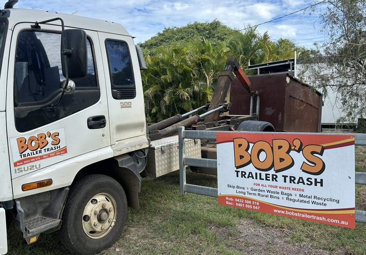 A White Truck Next to a Metal Trash Bin — Bob’s Trailer Trash in Rockhampton, QLD