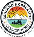 Ashland&rsquo;s Creekside Campground logo with sun, mountains, river, trees, and RV park text, Ashland, Oregon