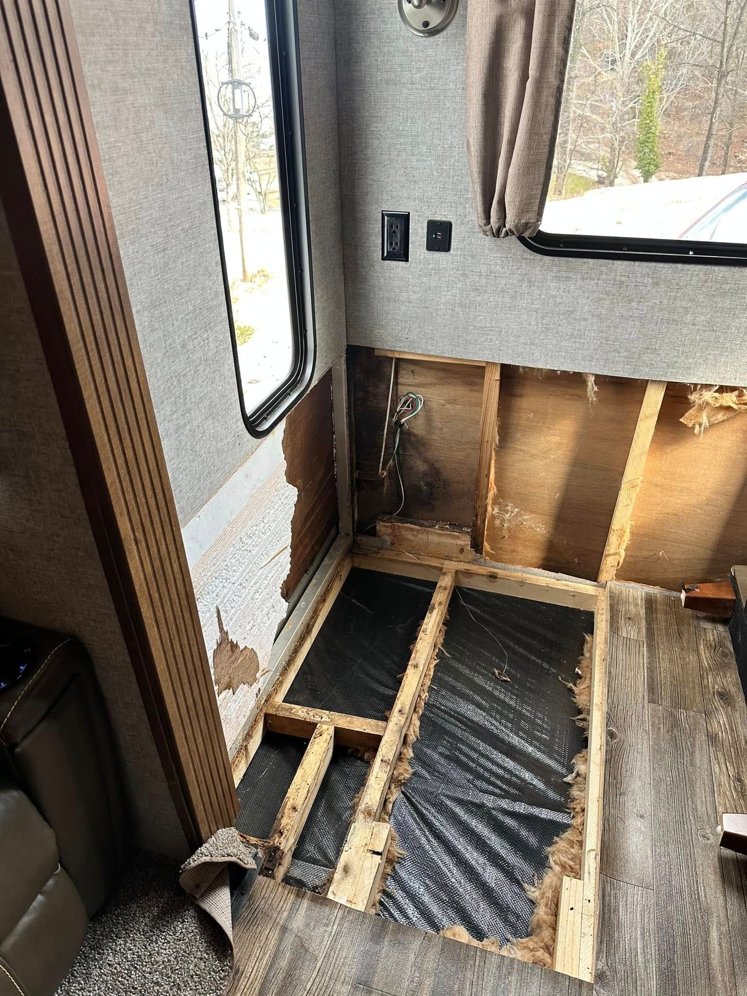 A rv is being remodeled and the floor is being removed.