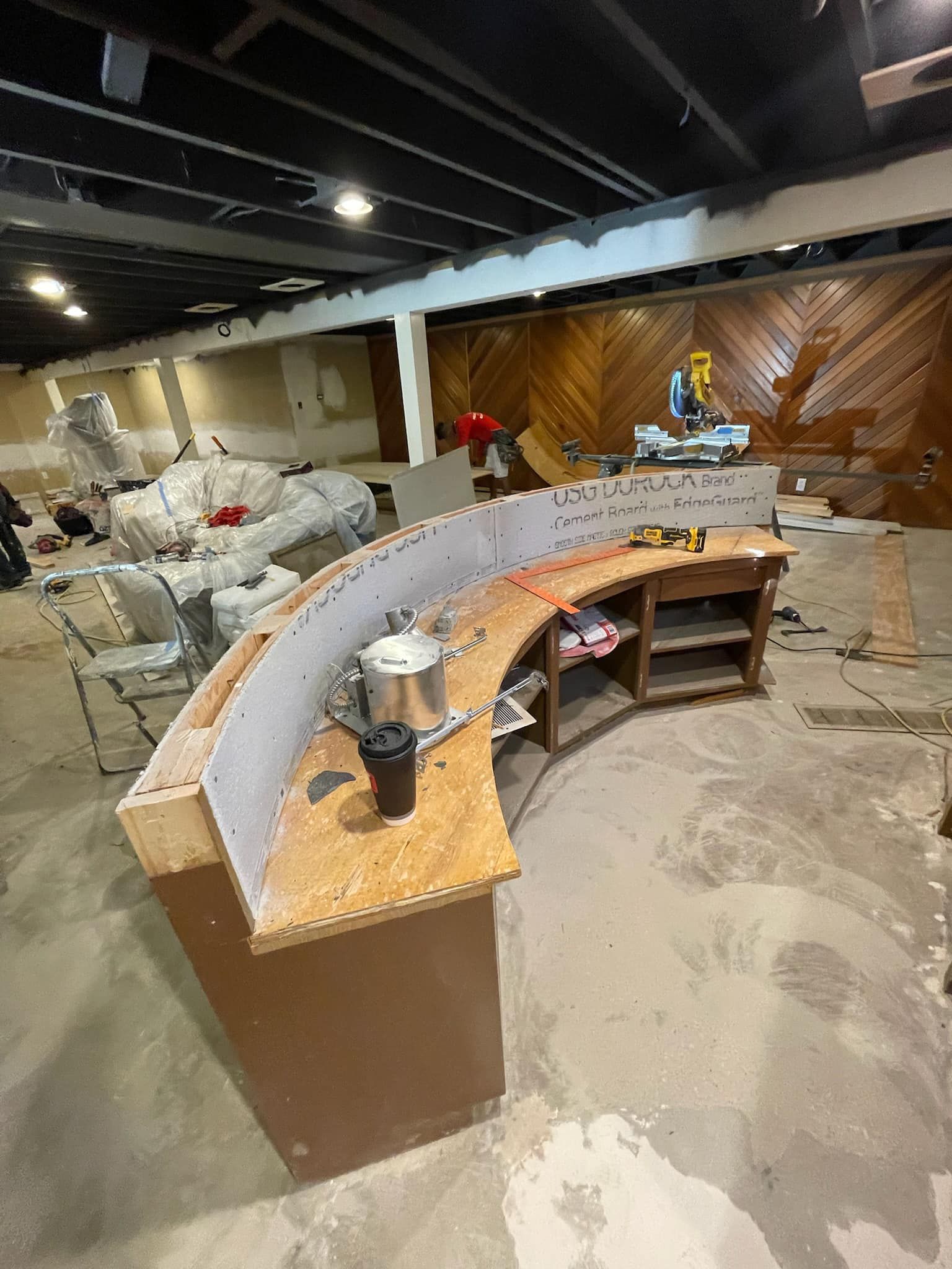 A large room with a curved counter in the middle of it.