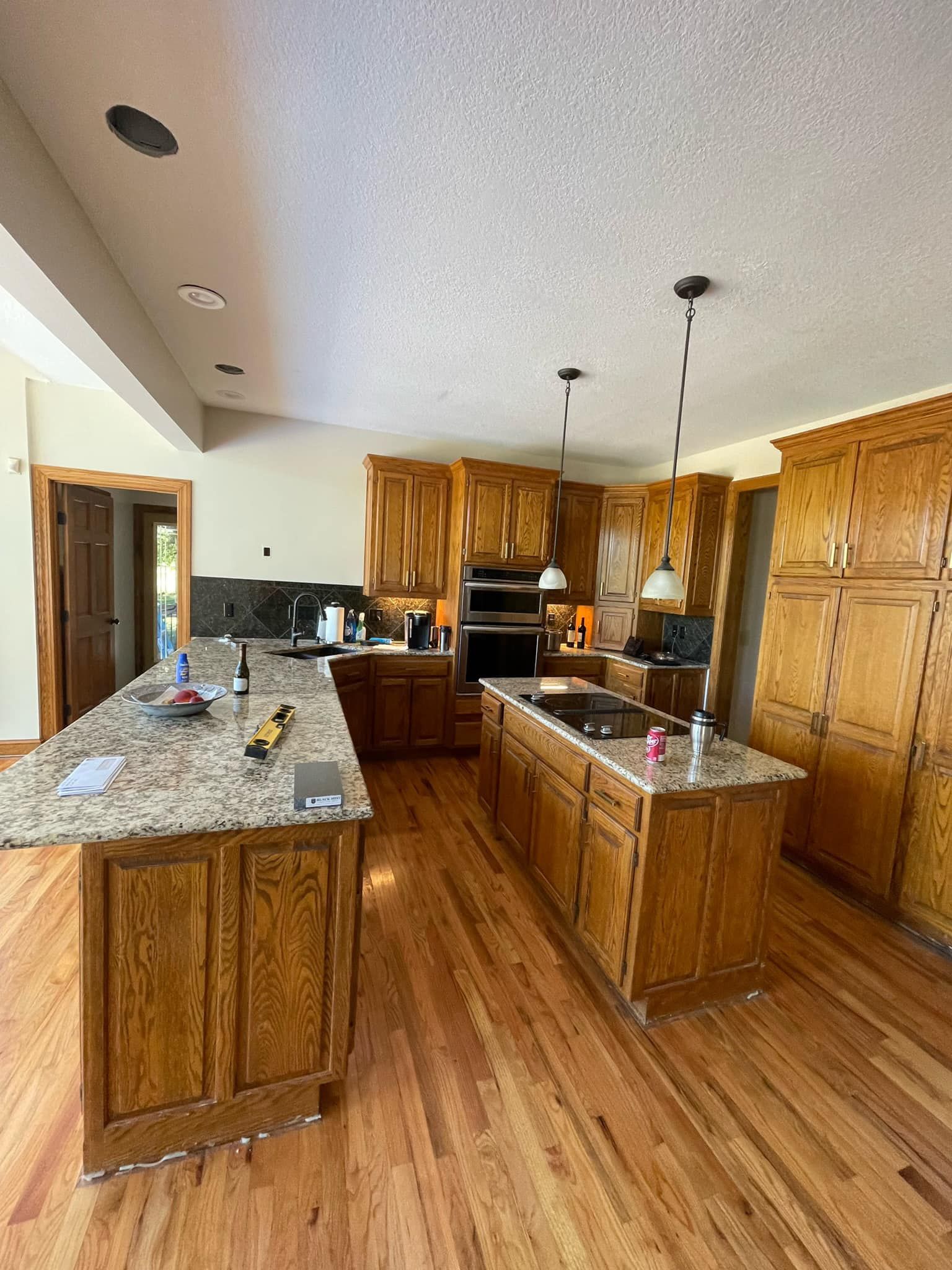 A large kitchen with wooden cabinets and granite counter tops.