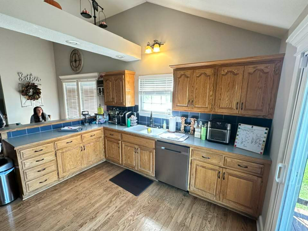 A kitchen with wooden cabinets and stainless steel appliances.