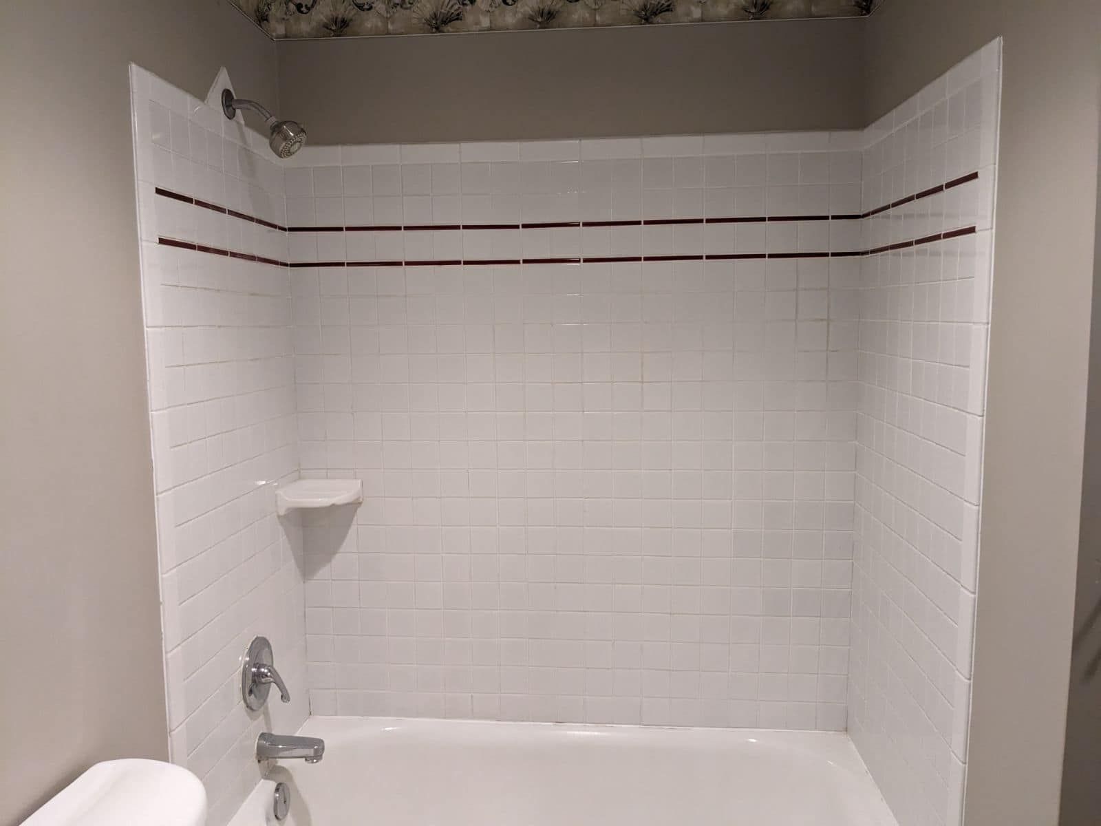 A bathroom with a bathtub , toilet and shower.