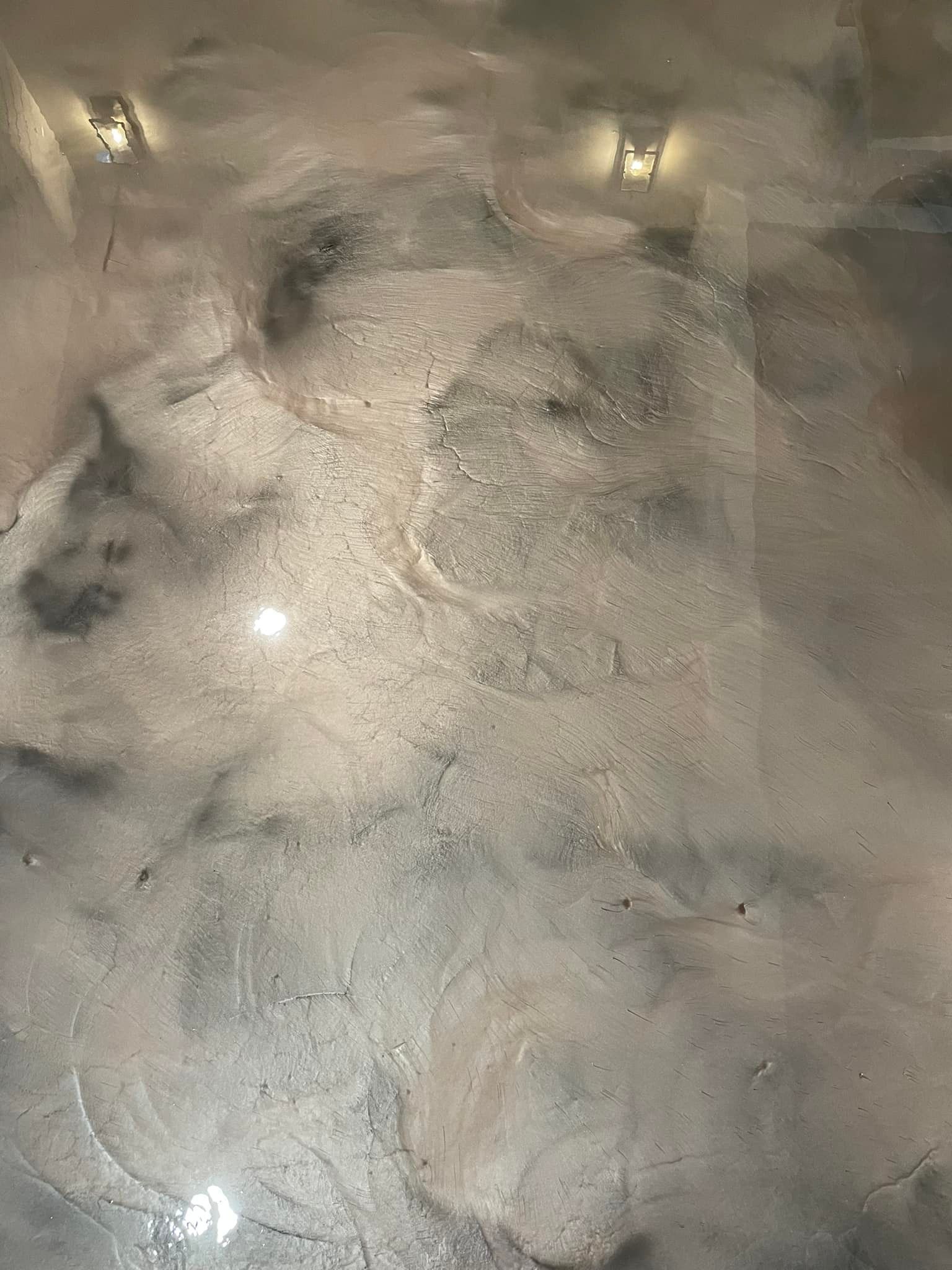 A close up of a marble floor with a metallic finish.