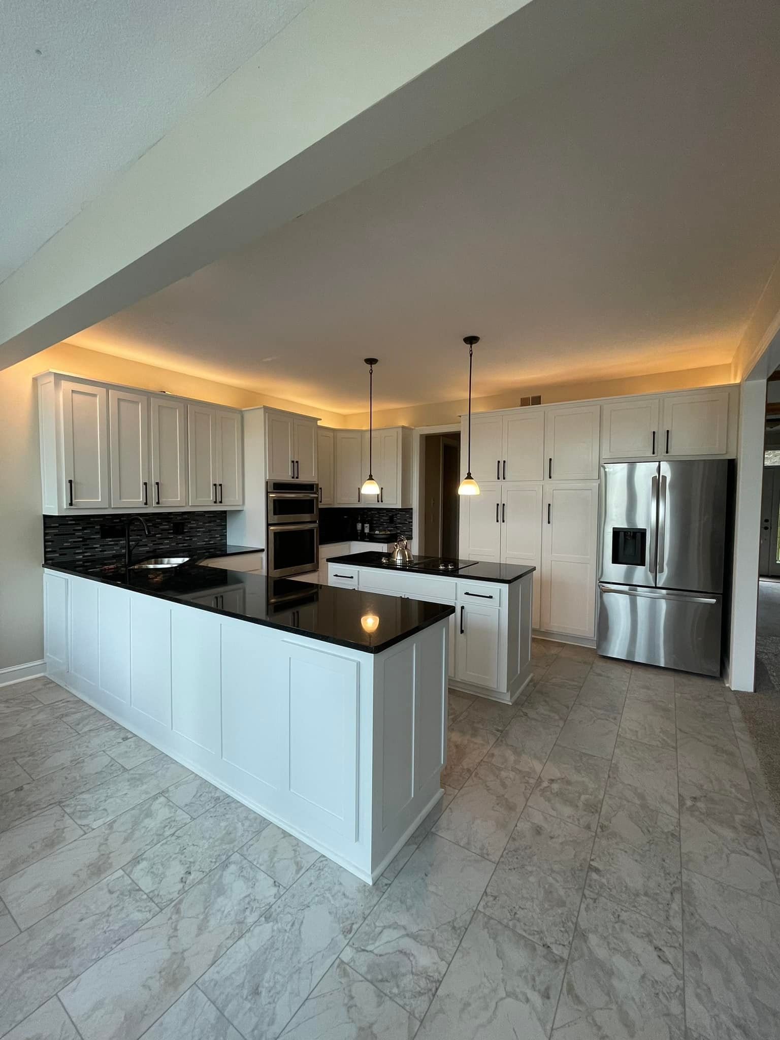 A kitchen with white cabinets and stainless steel appliances.