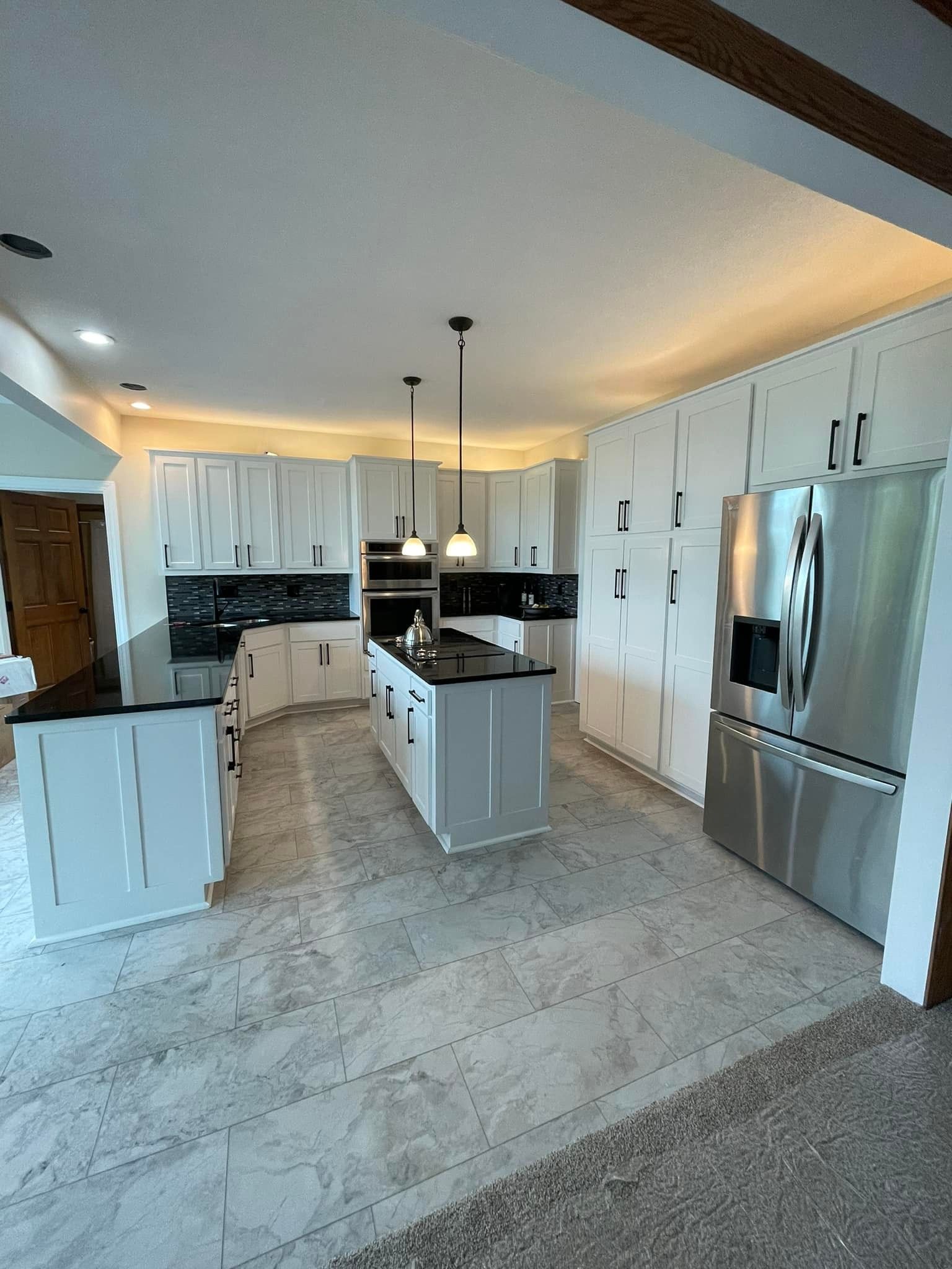 A kitchen with white cabinets and stainless steel appliances.