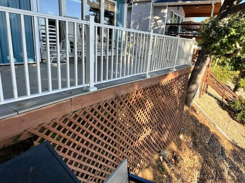 A deck with a white railing and a wooden deck.
