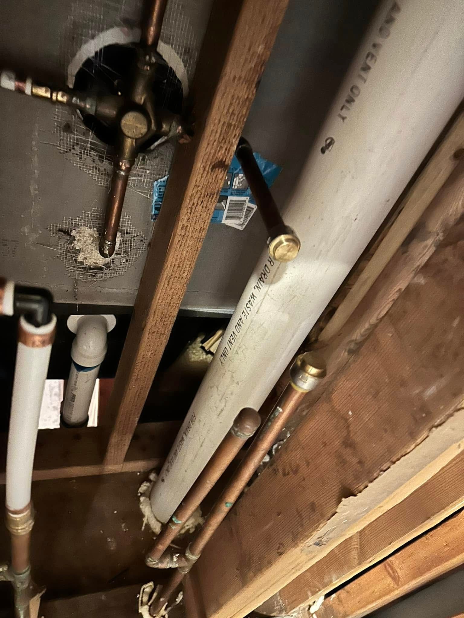A bunch of pipes are hanging from the ceiling of a room.