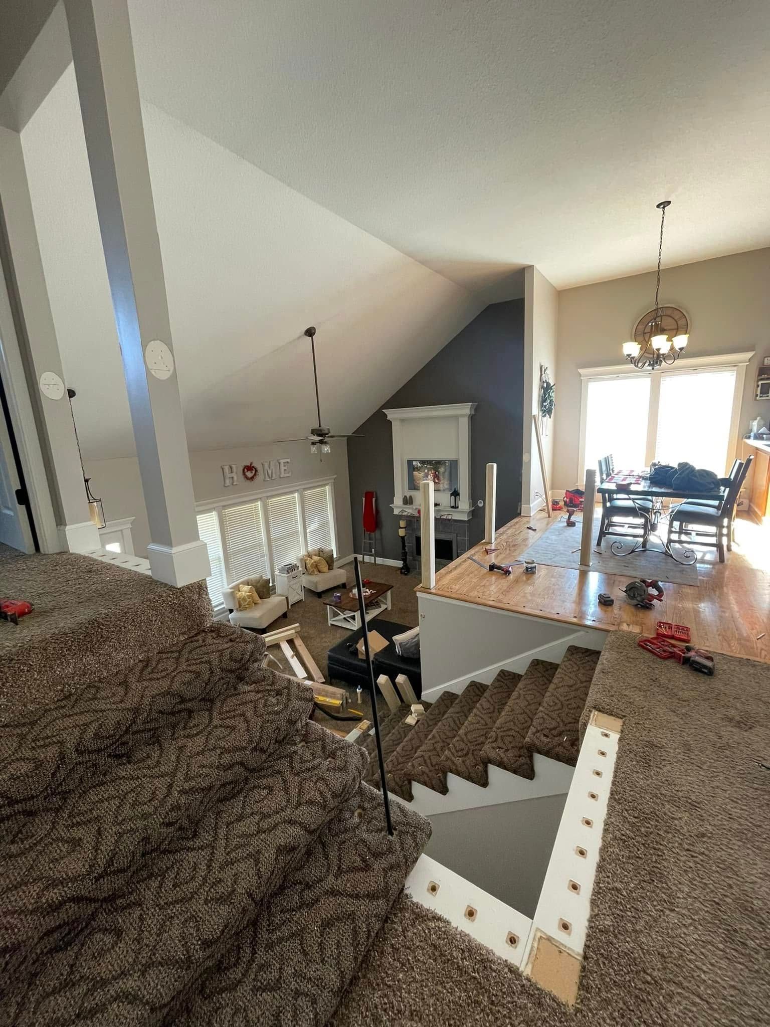 A view of a living room from the top of a staircase.