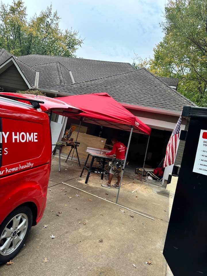 A red van is parked in front of a house.