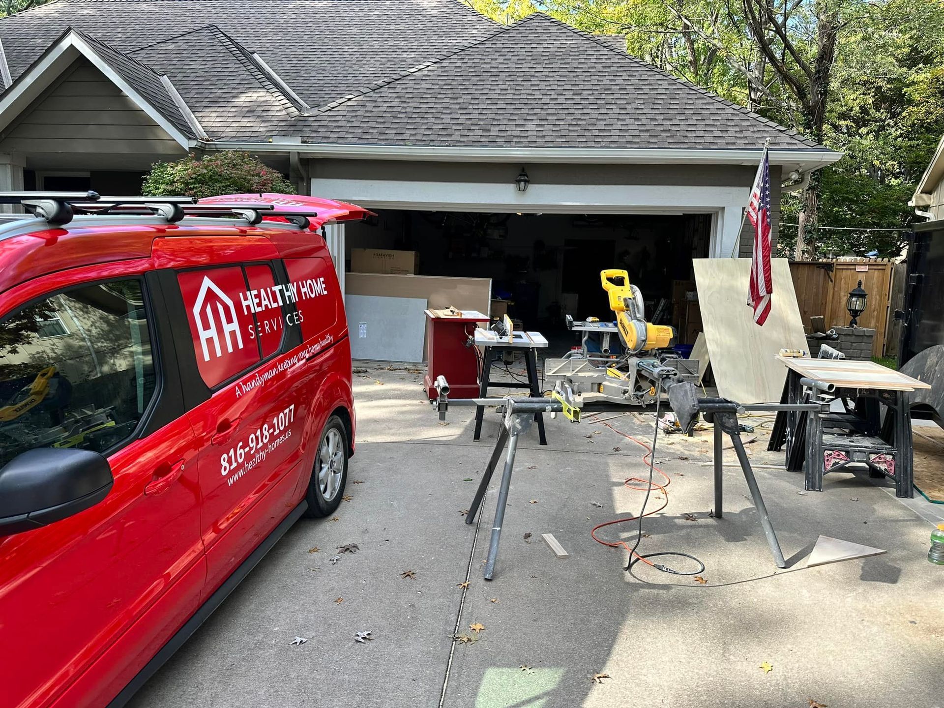 A red van is parked in front of a house.
