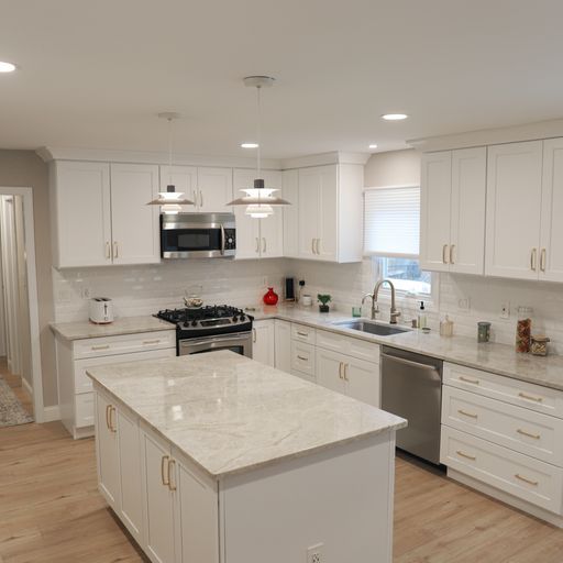A kitchen with white cabinets and stainless steel appliances.