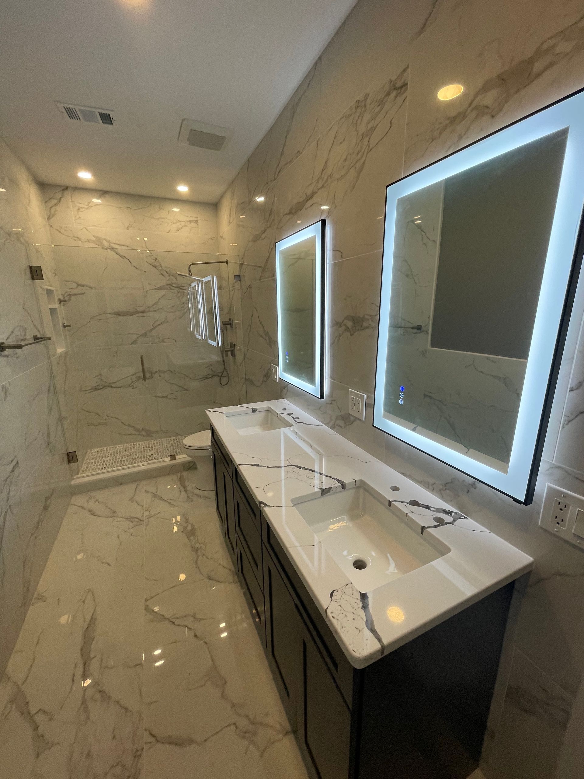 A bathroom with two sinks and two mirrors.