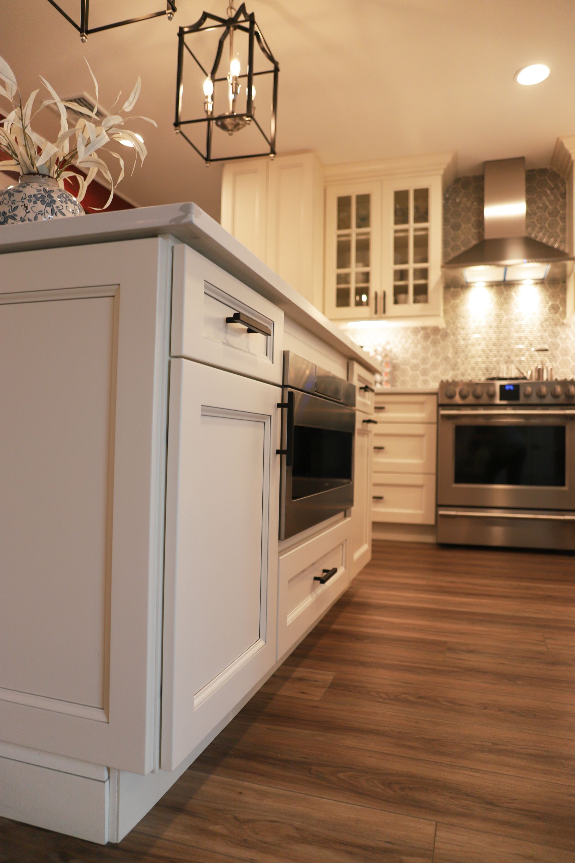 A kitchen with white cabinets and stainless steel appliances.