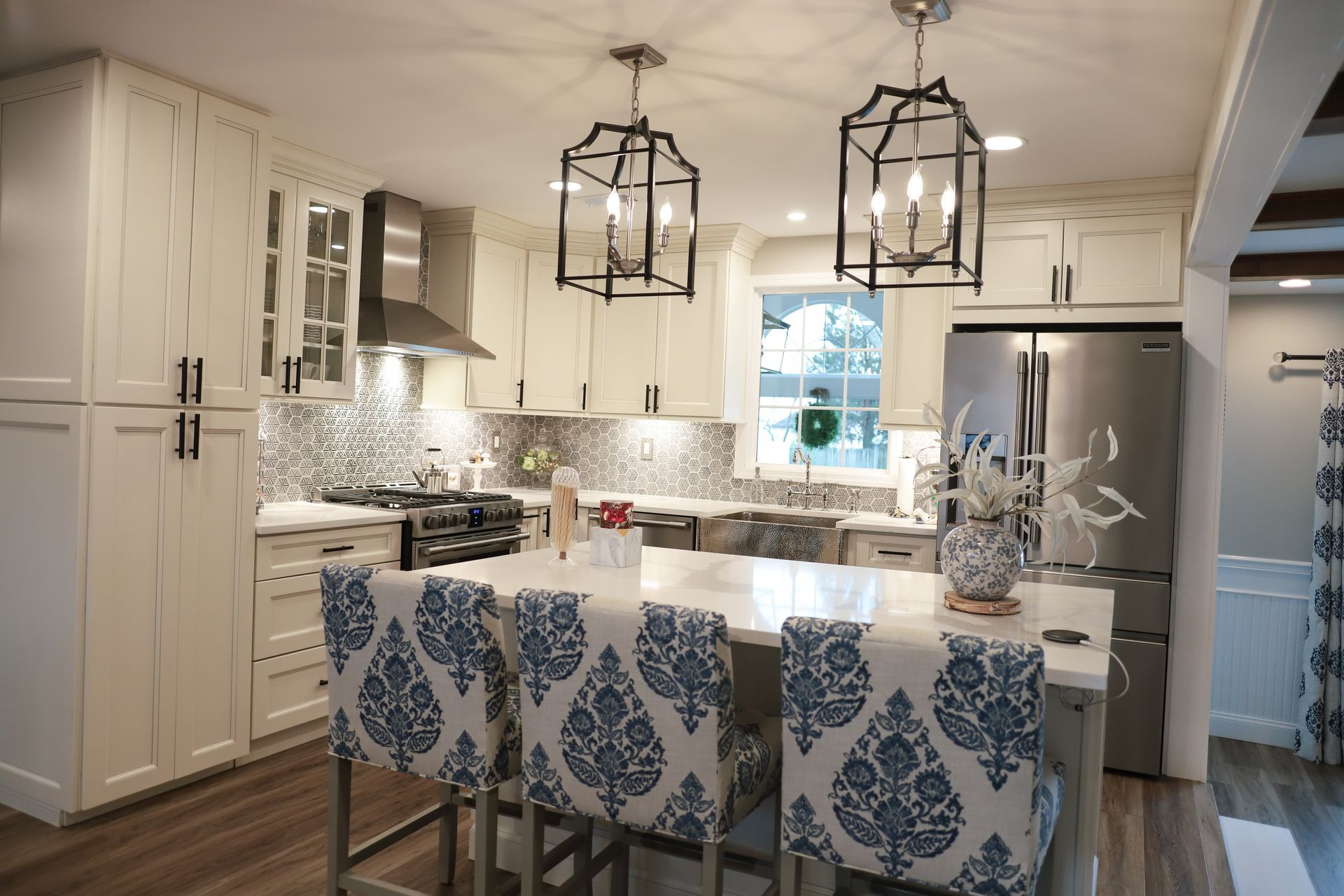 A kitchen with white cabinets and stainless steel appliances.