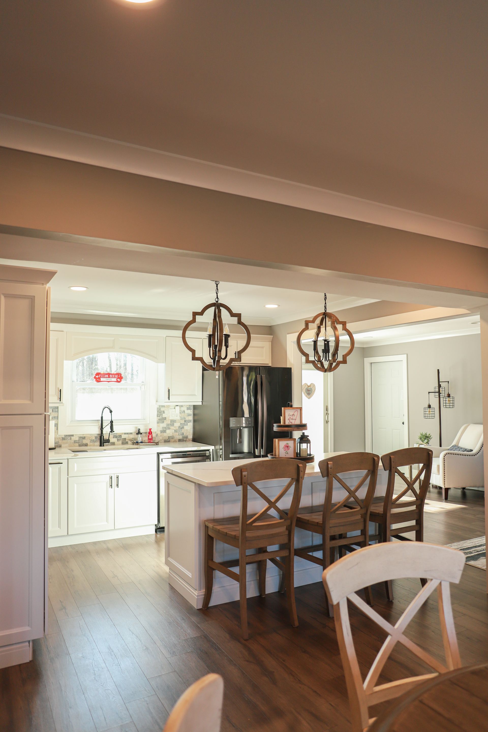 A kitchen and dining room in a house with a table and chairs.