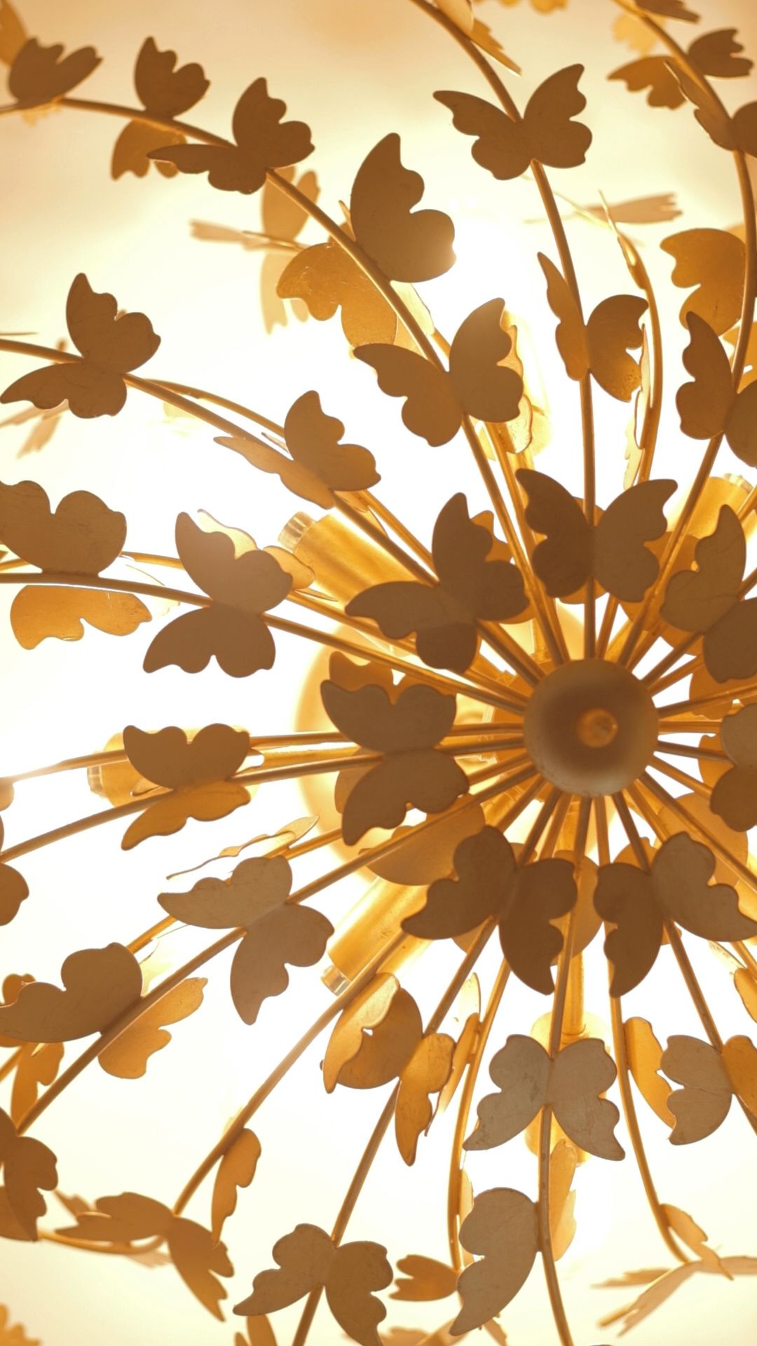 A close up of a chandelier with butterflies on it.