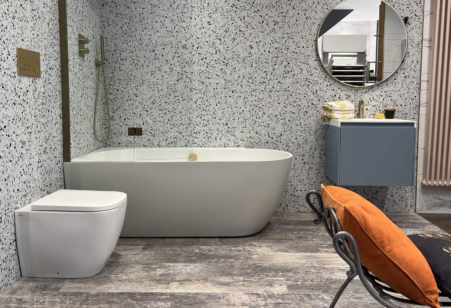 A bathroom with a bathtub , toilet , sink and mirror