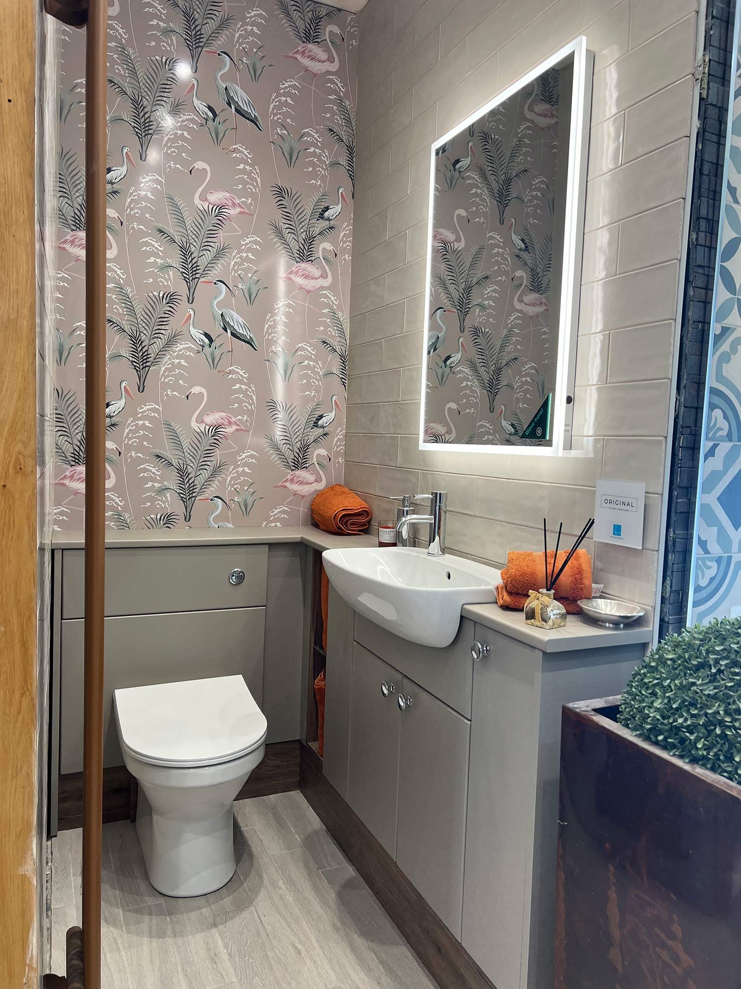 A bathroom with a toilet a sink and a mirror