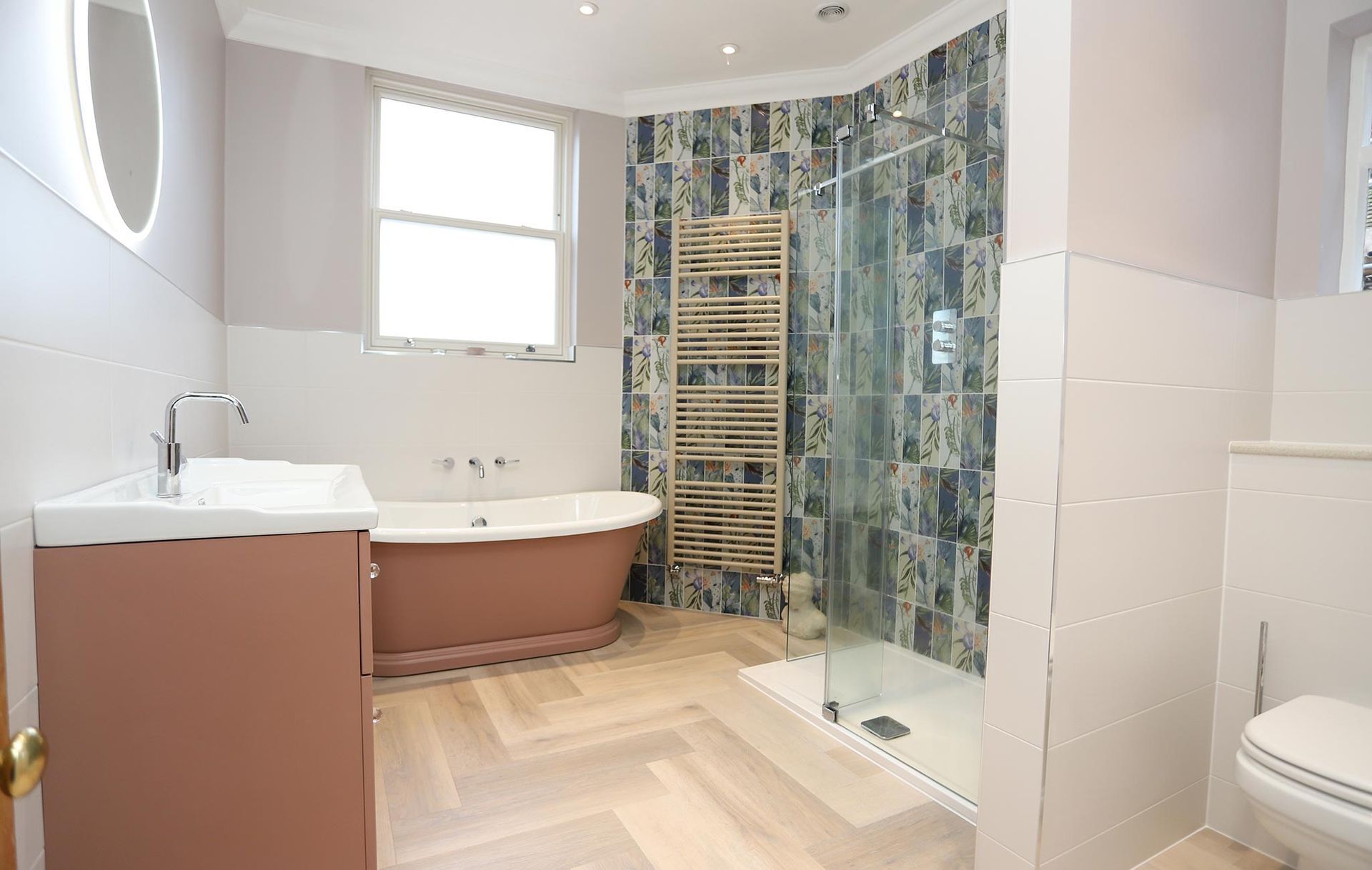 A bathroom with a bathtub , sink , toilet and shower.