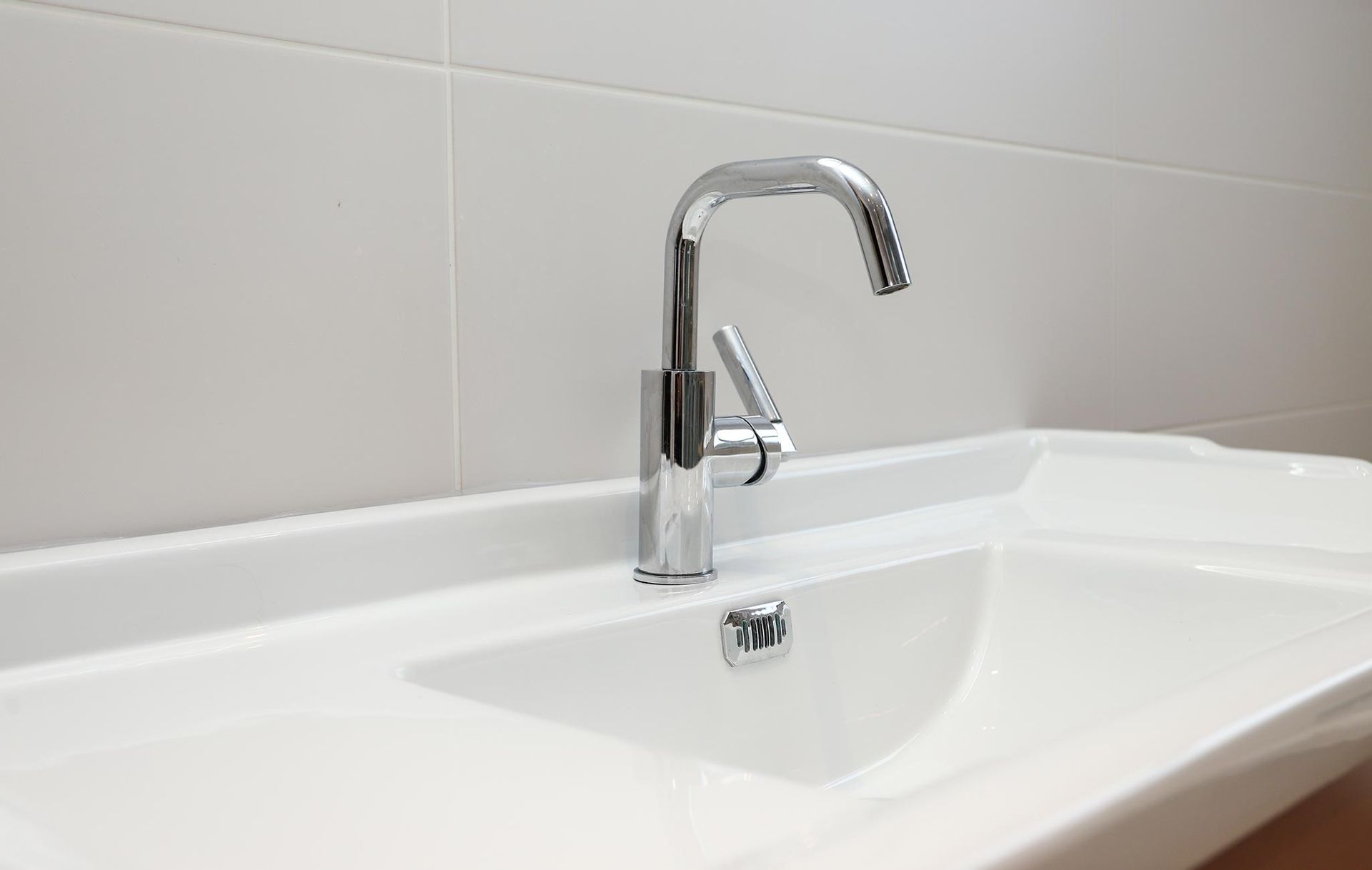 A bathroom sink with a chrome faucet and a white sink
