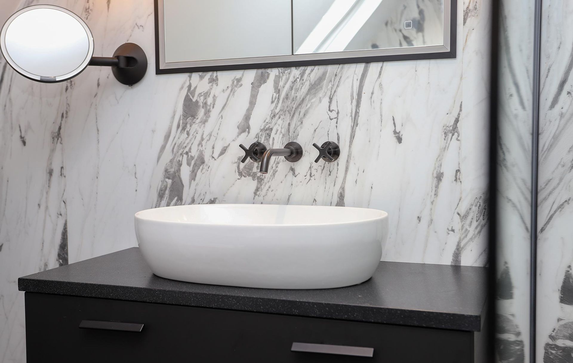 A bathroom with a sink and a mirror on the wall