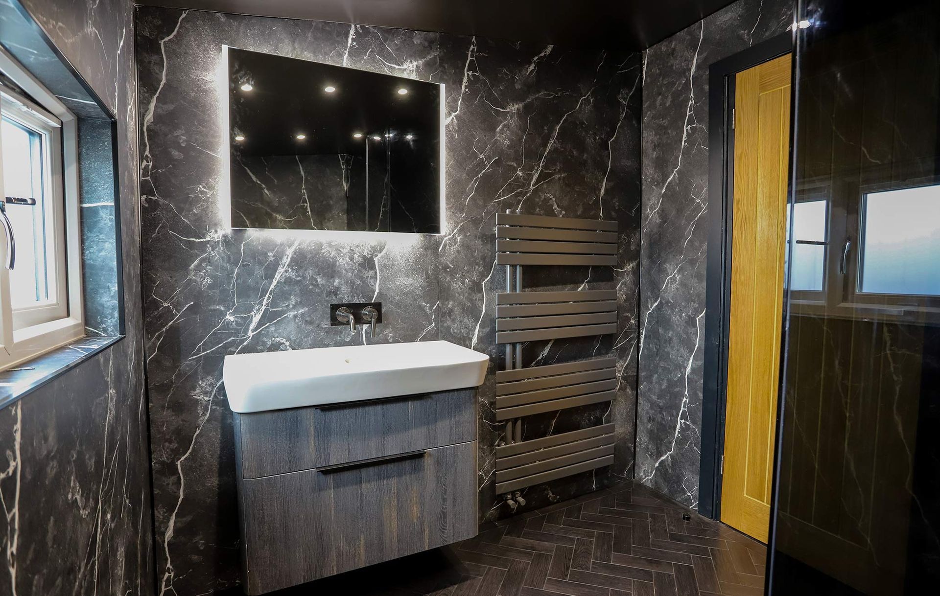 A bathroom with a sink a mirror and a towel rack