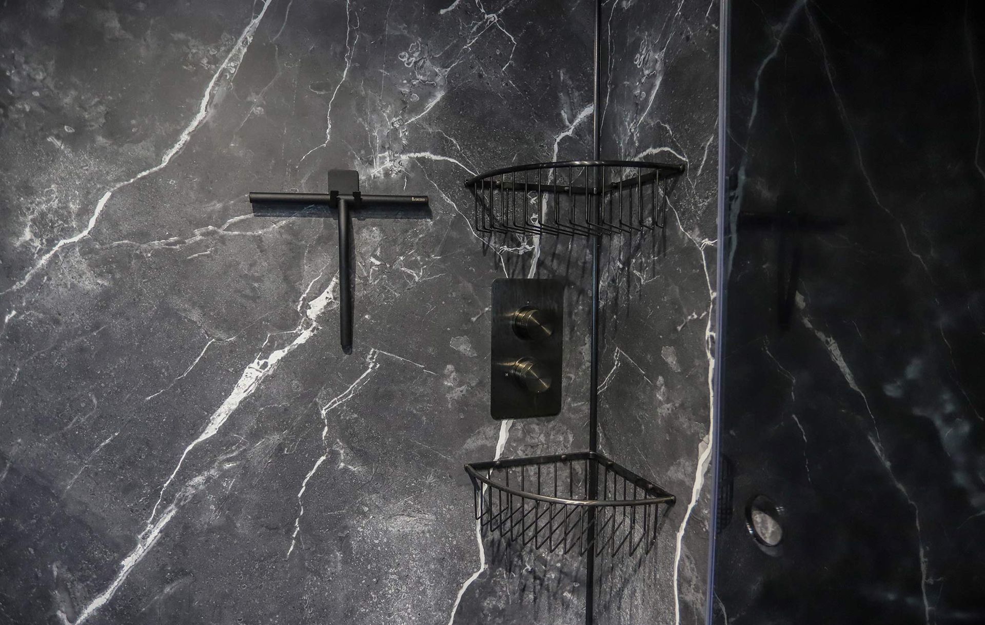 A black wall with a cross and a basket on it.