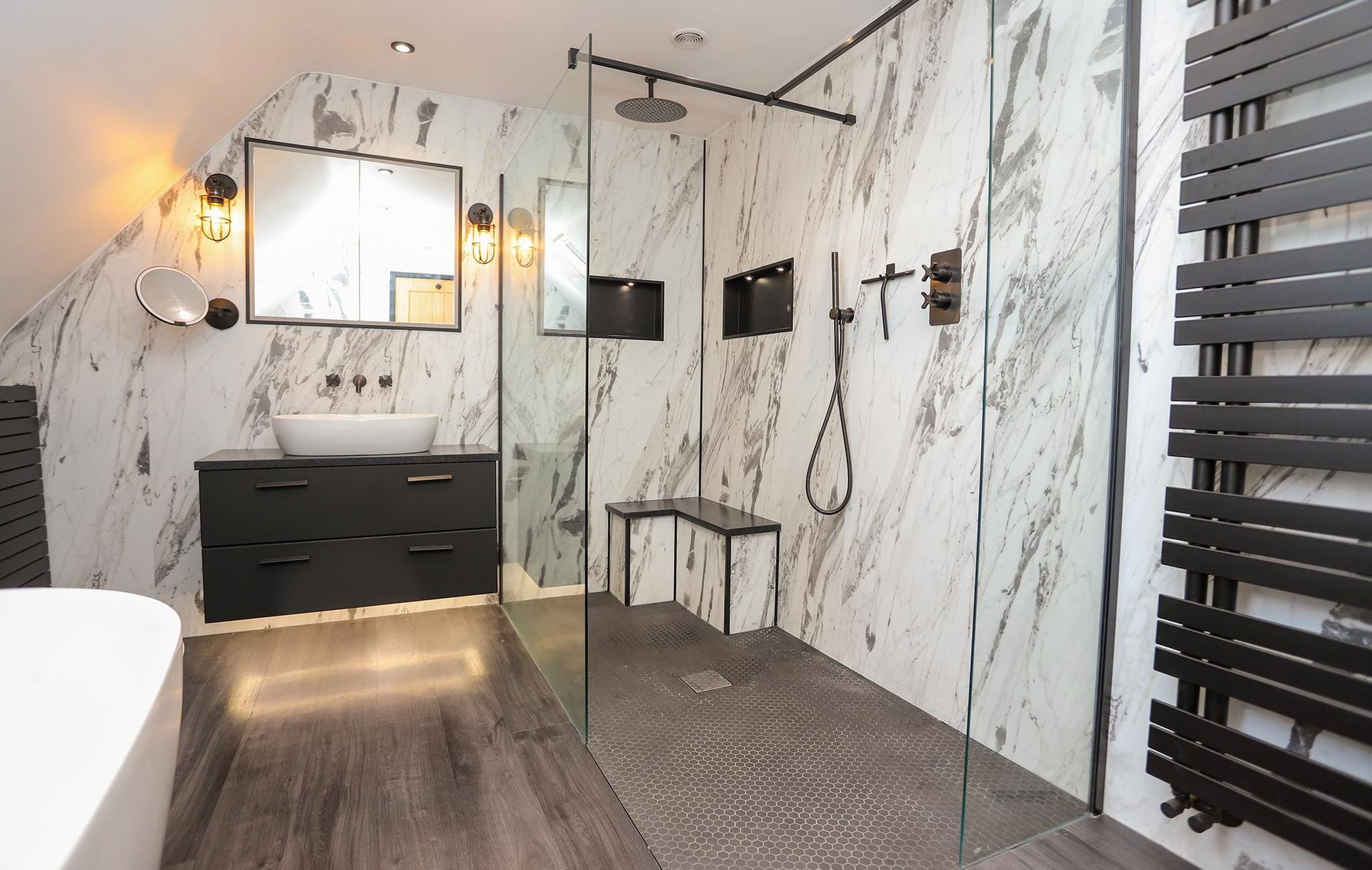 A bathroom with marble walls and a walk in shower