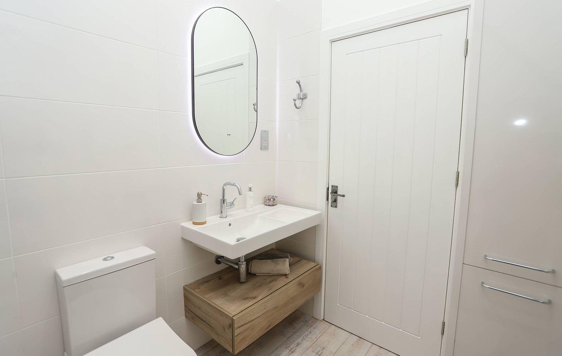A bathroom with a sink , toilet and mirror.