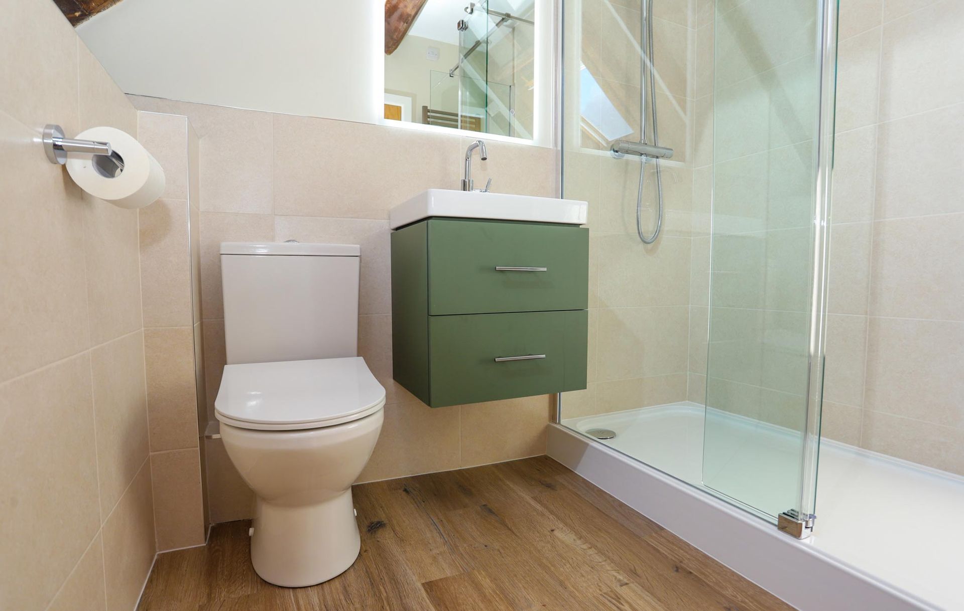 A bathroom with a toilet a sink and a walk in shower