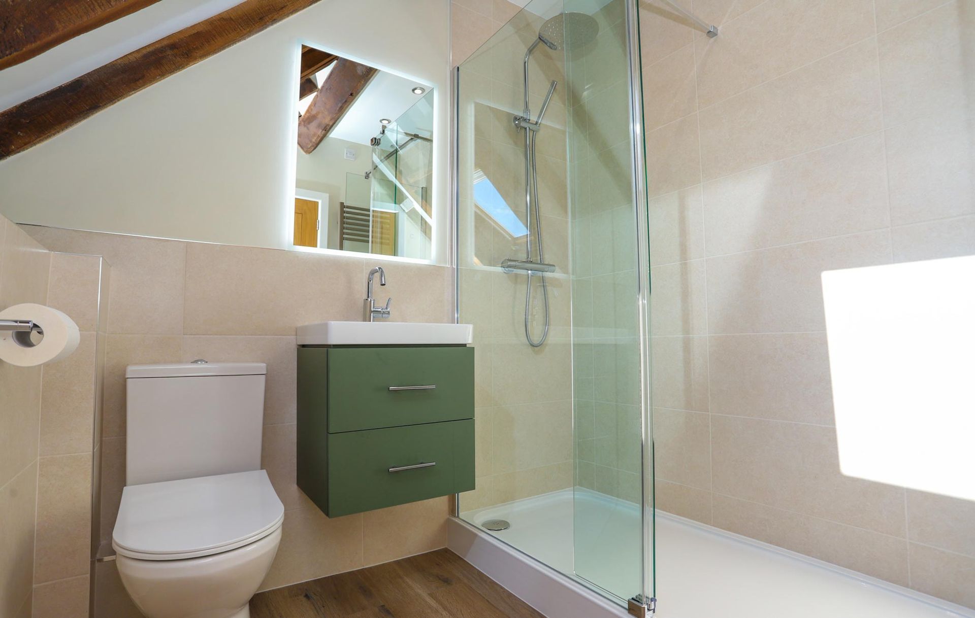 A bathroom with a toilet a sink and a walk in shower