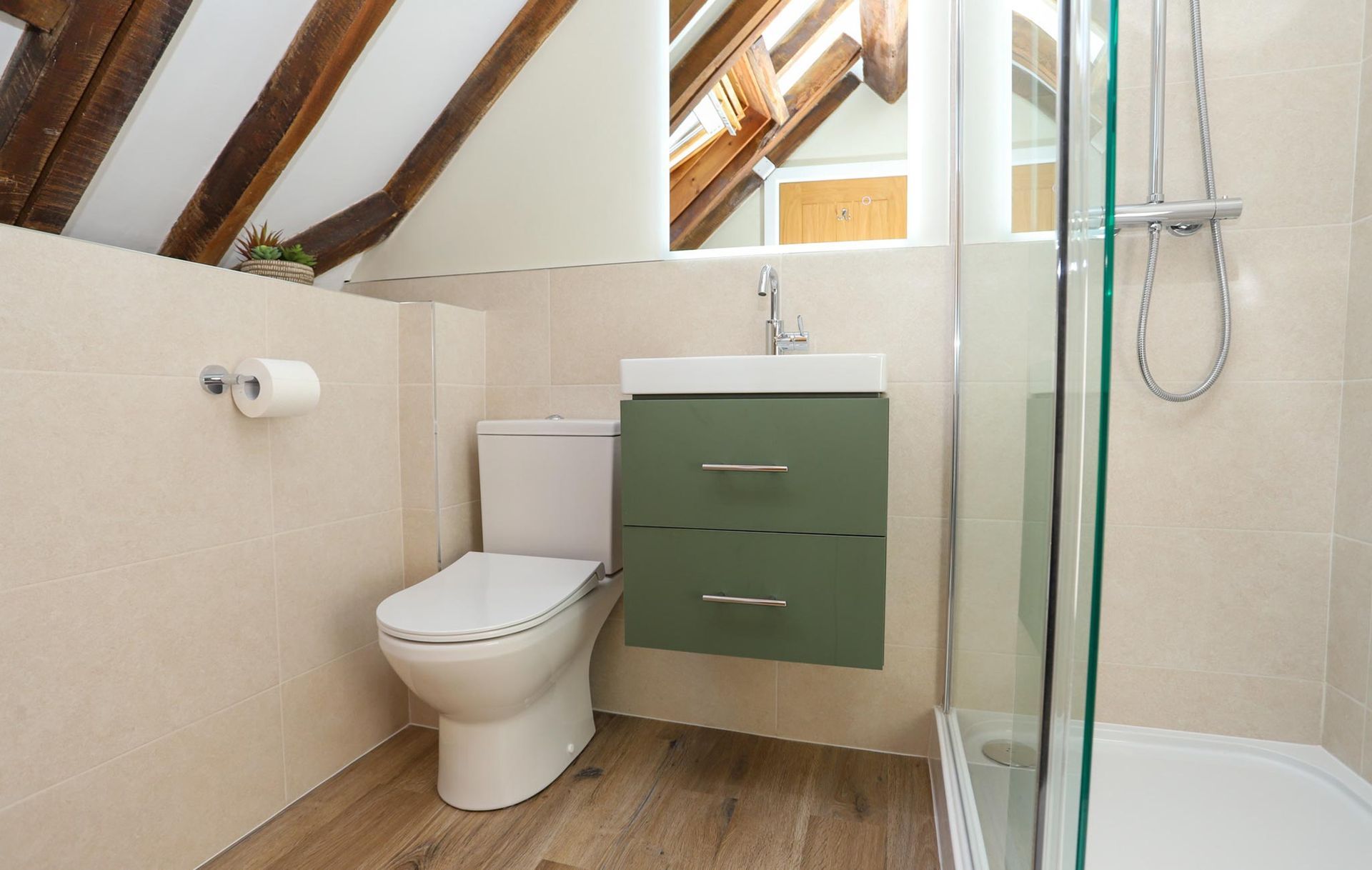 A bathroom with a toilet a sink and a shower