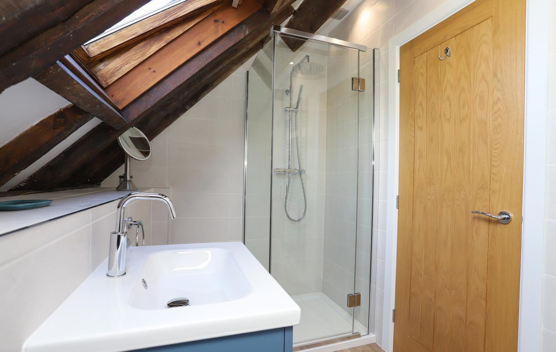 A bathroom with a sink and a walk in shower