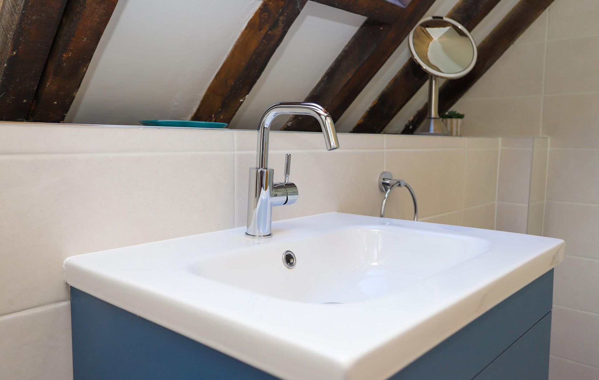 A bathroom sink with a faucet and a mirror